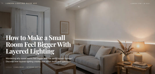 Small living room with a gray sofa, a warm table lamp, and indirect wall lighting, illustrating layered lighting.