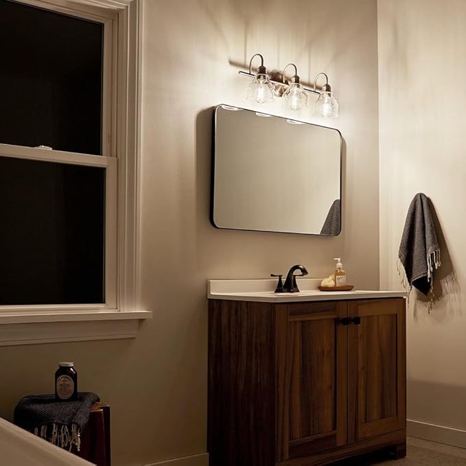 Kichler Avery 3-Light Bathroom Vanity Light Fixture with Clear Seeded Glass, Industrial Farmhouse Style in Natural Brass for Damp Locations (24" x 9.25"), 45973NBR